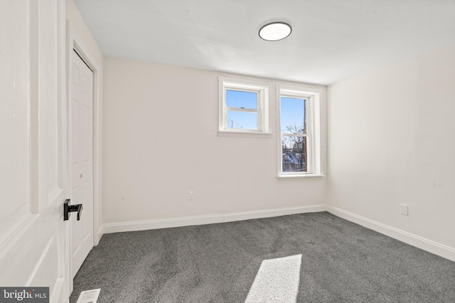 unfurnished bedroom with carpet floors, baseboards, visible vents, and a closet