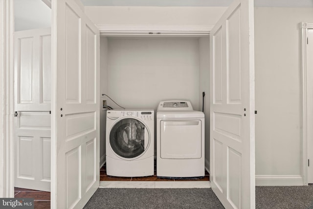 washroom featuring carpet floors, laundry area, baseboards, and washer and clothes dryer