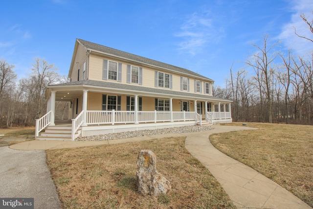 farmhouse with a front yard and covered porch