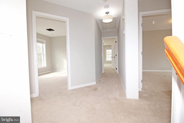 hall featuring carpet, attic access, visible vents, and baseboards