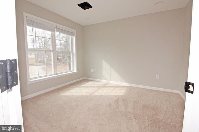 carpeted empty room with baseboards