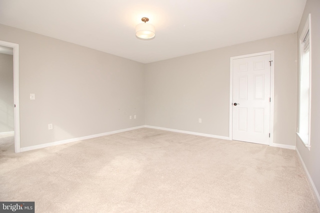 empty room with light carpet and baseboards