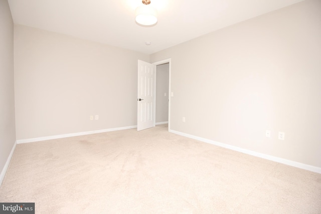 empty room with light carpet and baseboards