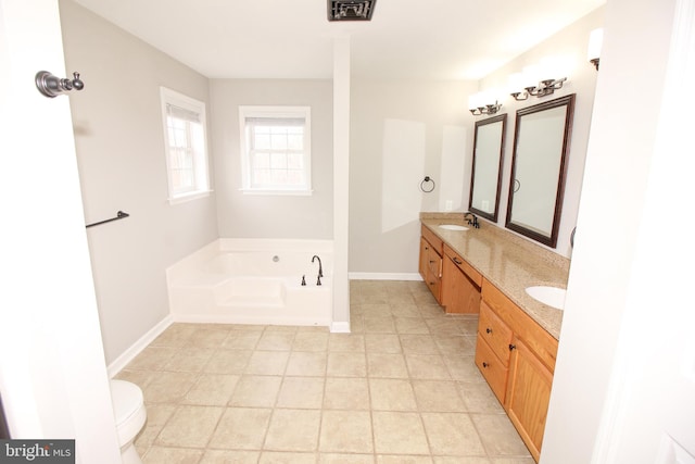 full bath featuring double vanity, a sink, a bath, and baseboards