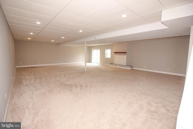 unfurnished room with a paneled ceiling, carpet, baseboards, and recessed lighting