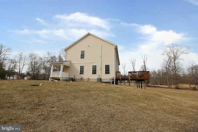 back of house with a yard and a wooden deck