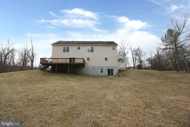 back of property with a lawn and a wooden deck