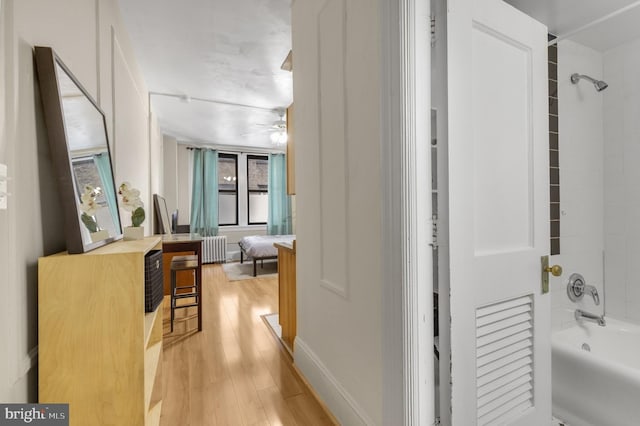 hall with radiator and light wood-style flooring