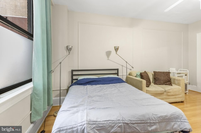 bedroom with ceiling fan and wood finished floors