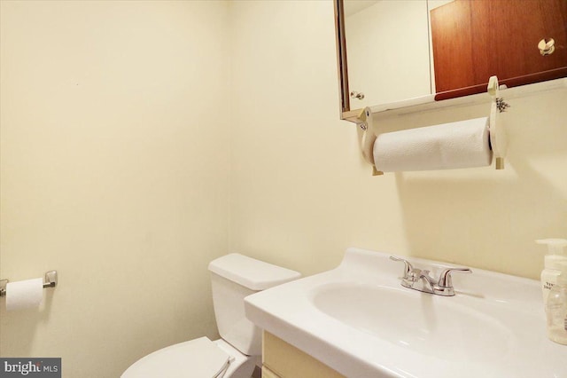 bathroom featuring toilet and vanity