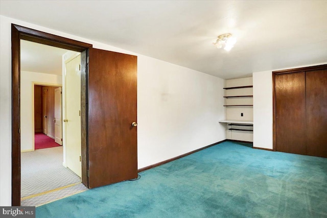 unfurnished bedroom with a closet, carpet flooring, and baseboards