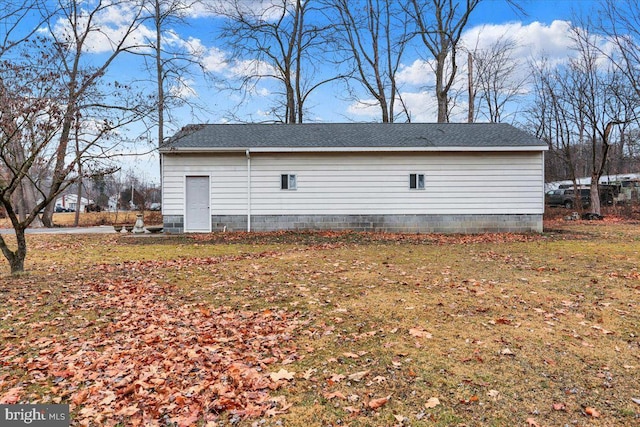 view of side of home with a lawn