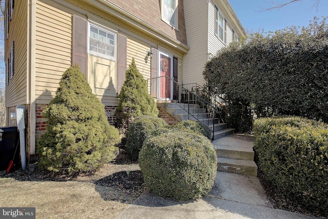 doorway to property featuring brick siding