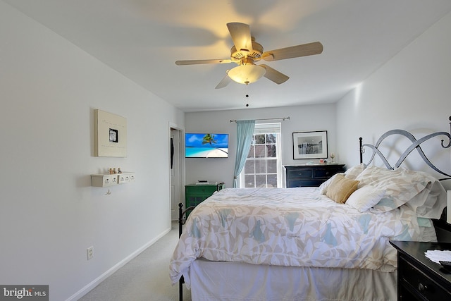 carpeted bedroom featuring ceiling fan and baseboards