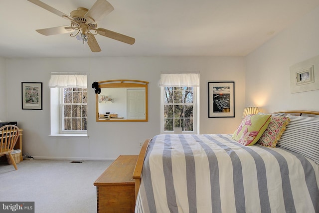 bedroom with carpet floors, ceiling fan, visible vents, and baseboards