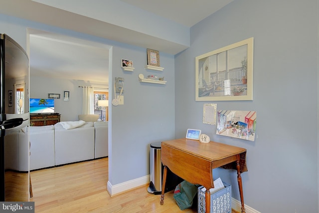 dining room featuring light wood-style floors and baseboards