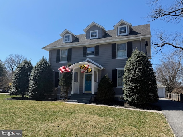 view of front of home with a front yard and a garage