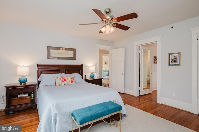 bedroom with baseboards, wood finished floors, and ceiling fan