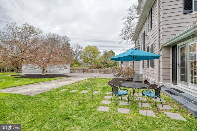 view of yard featuring cooling unit, fence, and a patio