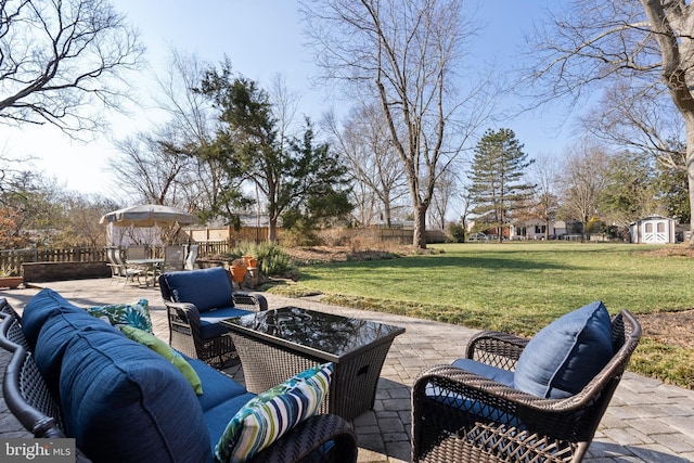 view of patio with an outdoor hangout area, outdoor dining area, a fenced backyard, an outbuilding, and a storage unit