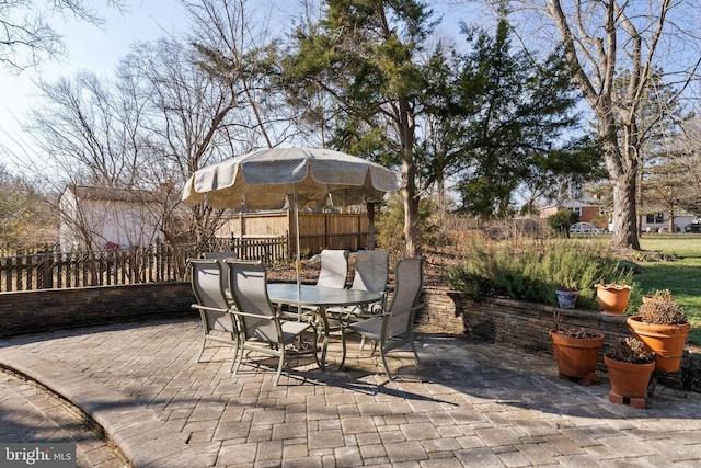 view of patio with outdoor dining area and fence