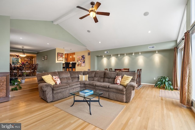 living area featuring high vaulted ceiling, baseboards, beam ceiling, visible vents, and wood finished floors