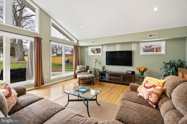 living room featuring wood finished floors, recessed lighting, and visible vents