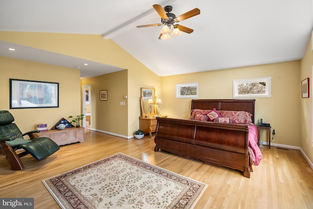 bedroom with lofted ceiling with beams, baseboards, and wood finished floors