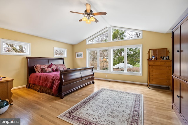bedroom featuring a ceiling fan, lofted ceiling with beams, baseboards, and light wood-type flooring