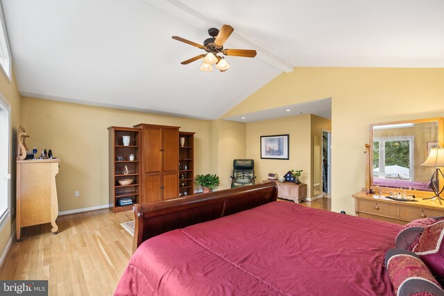 bedroom featuring lofted ceiling with beams, baseboards, ceiling fan, and light wood-style flooring