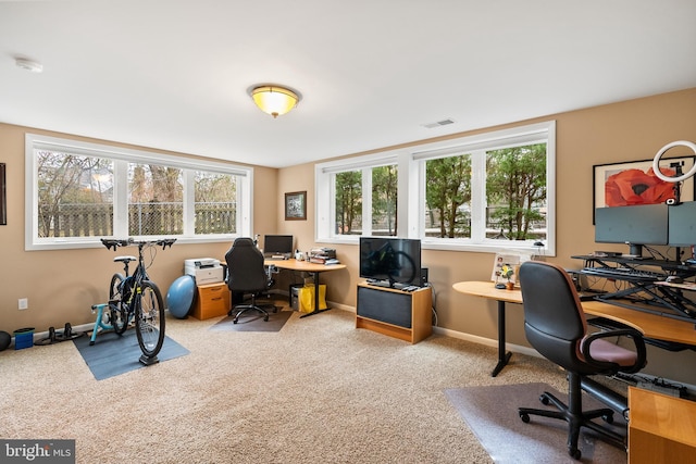 carpeted office featuring baseboards and visible vents
