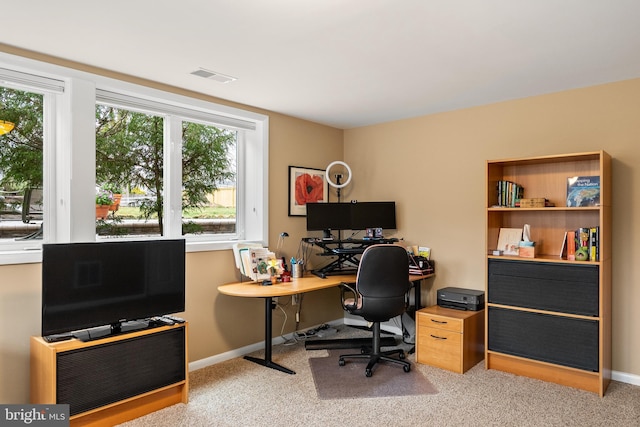 carpeted office space with baseboards and visible vents
