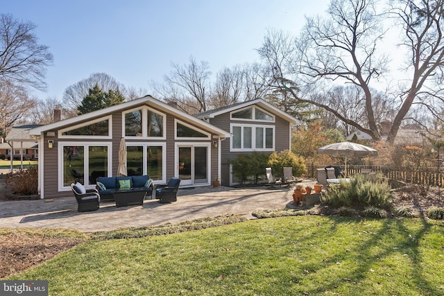 back of property featuring an outdoor living space, a lawn, and a patio