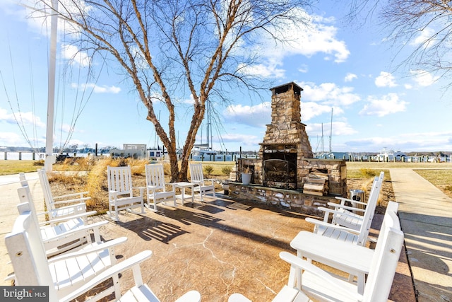 view of patio featuring an outdoor stone fireplace