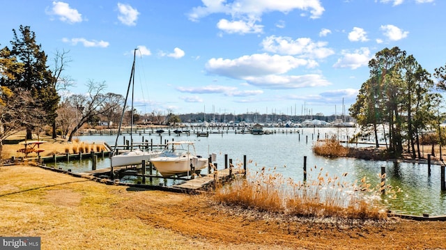 dock area with a water view and boat lift