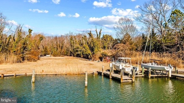 dock area with a water view and boat lift