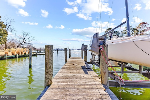 dock area with a water view and boat lift