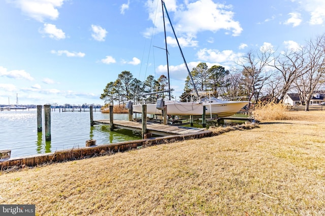 dock area featuring a lawn, a water view, and boat lift