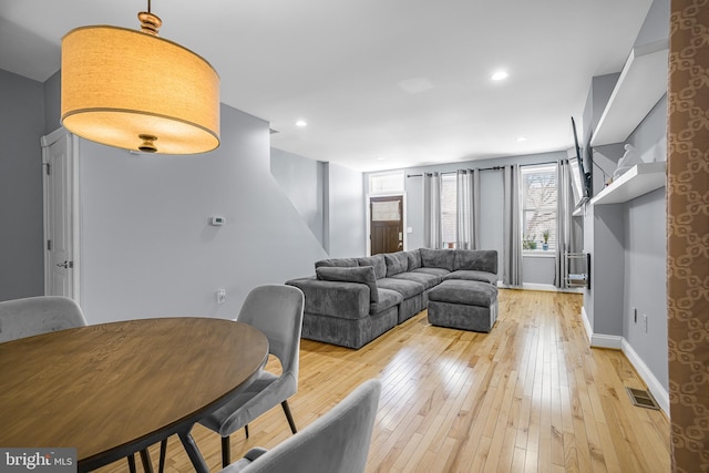 living room with light wood-style floors, recessed lighting, visible vents, and baseboards