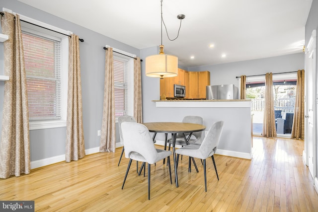 dining space featuring baseboards, recessed lighting, and light wood-style floors