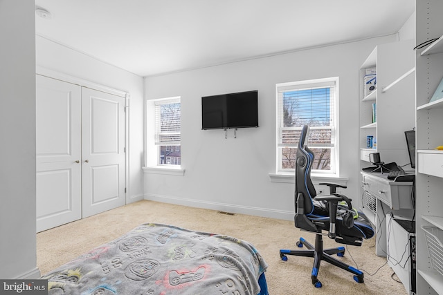 carpeted bedroom featuring visible vents, baseboards, and a closet