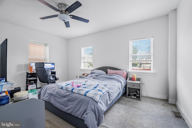 bedroom featuring carpet floors, visible vents, baseboards, and a ceiling fan