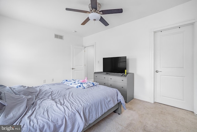 bedroom with light carpet, baseboards, visible vents, and a ceiling fan