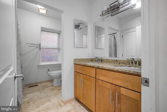 bathroom featuring baseboards, visible vents, a sink, and toilet