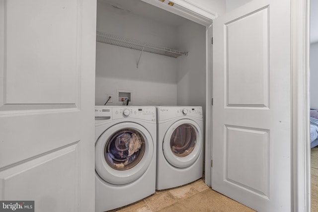 laundry room with laundry area and washer and clothes dryer