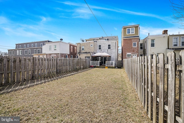 view of yard featuring a residential view, a fenced backyard, and a gazebo