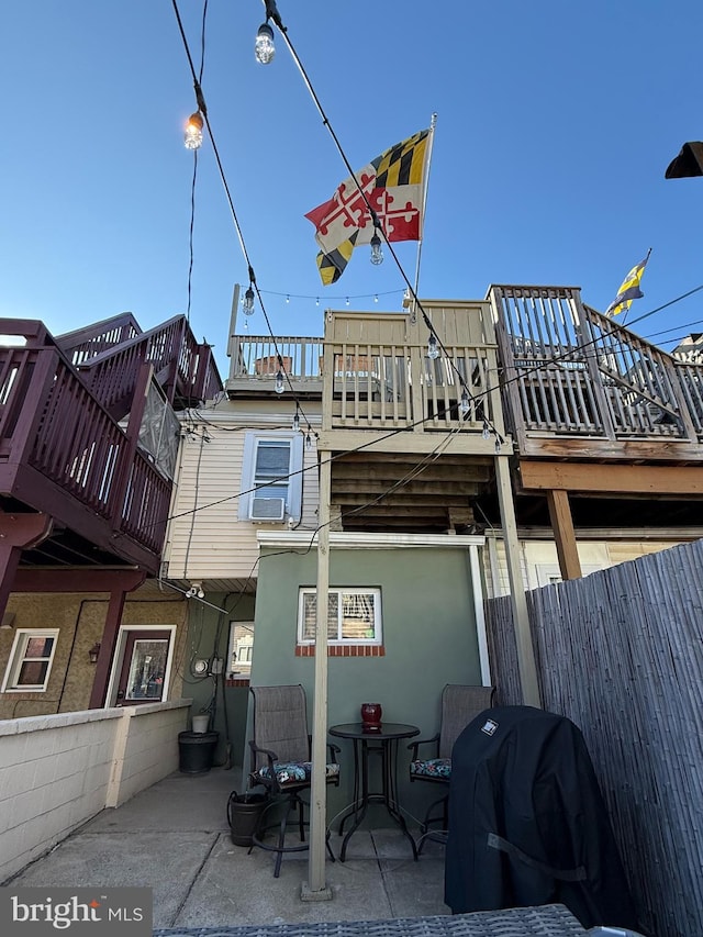 back of property with stucco siding, fence, and a patio