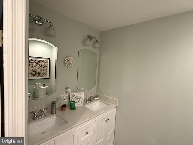 bathroom with a sink and double vanity