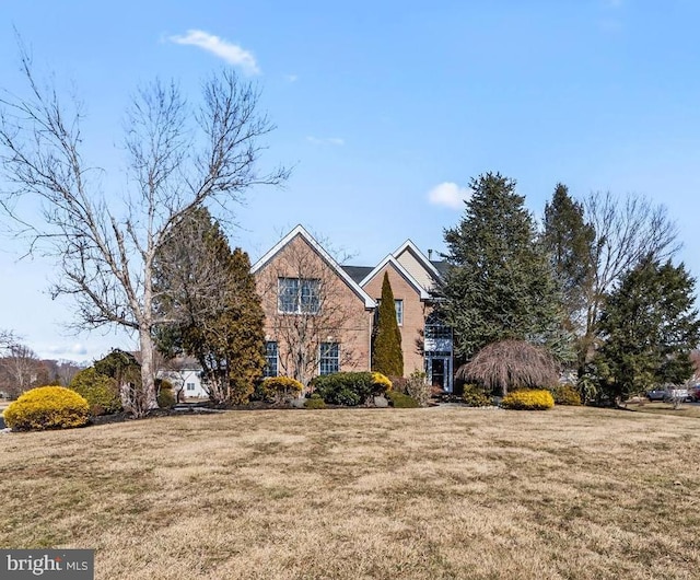 traditional-style home with a front lawn