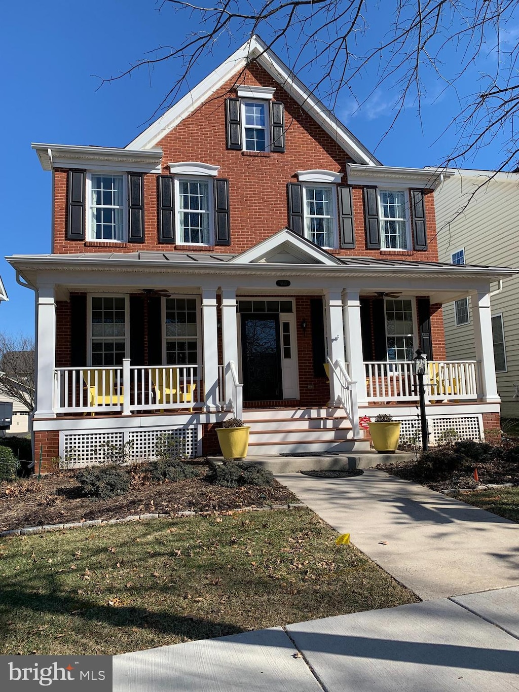 view of front of house with brick siding and a porch
